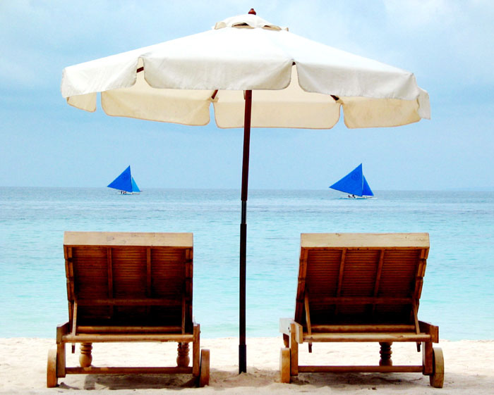 sun lounge chairs by the beach in boracay philippines