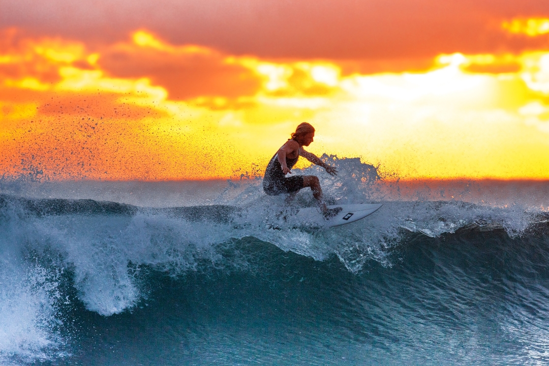 man surfing at sunset
