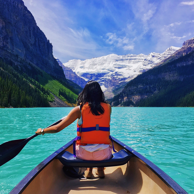 A person canoeing on a lake